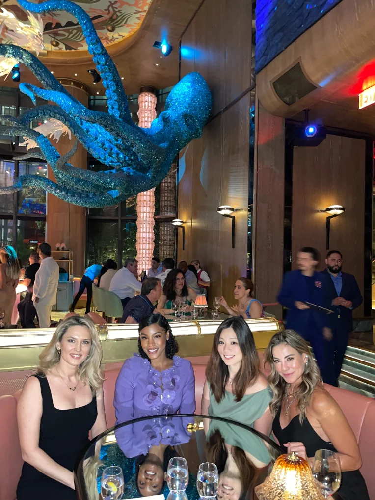 Guests in a lounge beneath a sculptural octopus installation